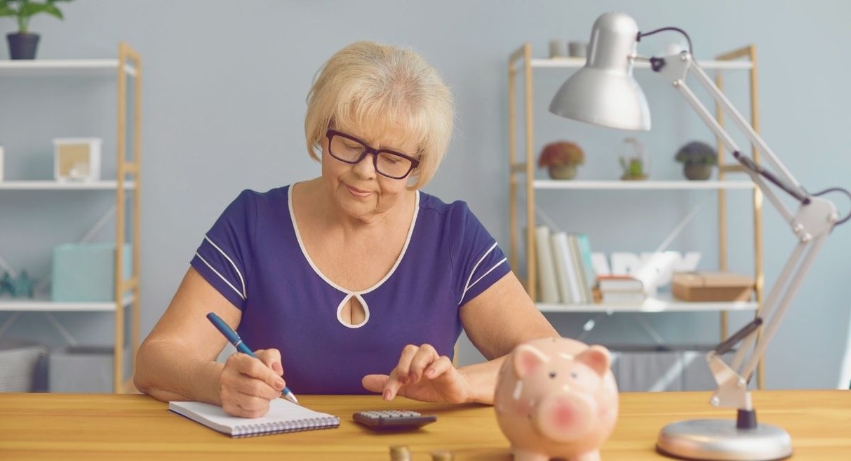 Femme senior faisant ses comptes de retraite avec calculatrice